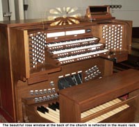 "The beautiful rose window at the back of the church is reflected in the music rack."